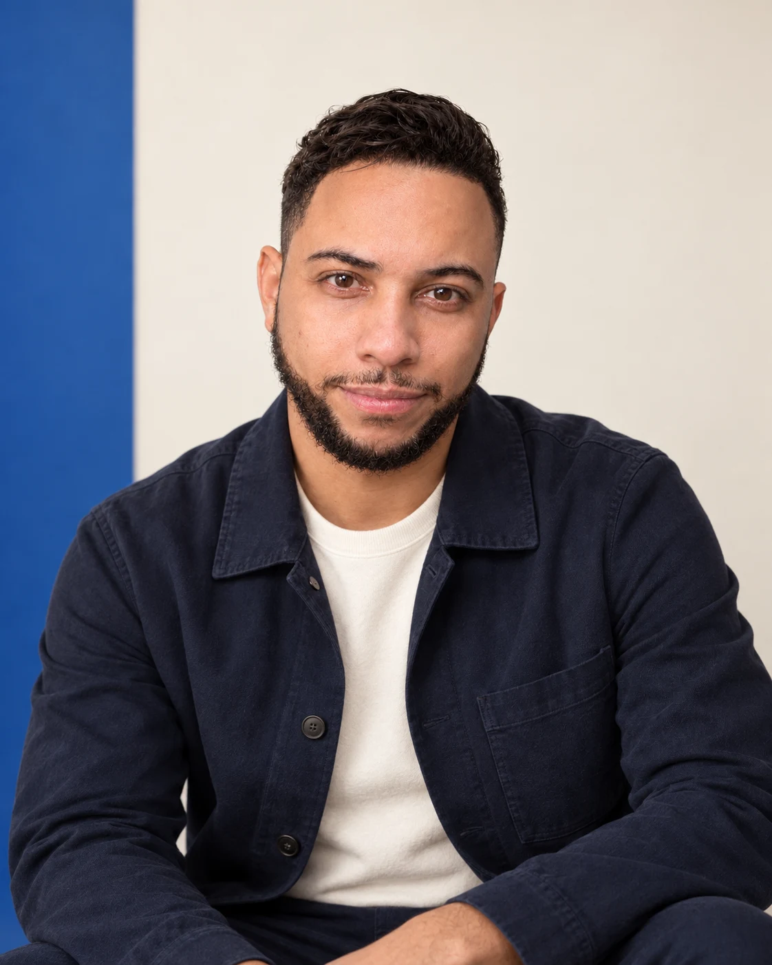Alfredo Mercedes in a navy jacket against a cream and blue backdrop.